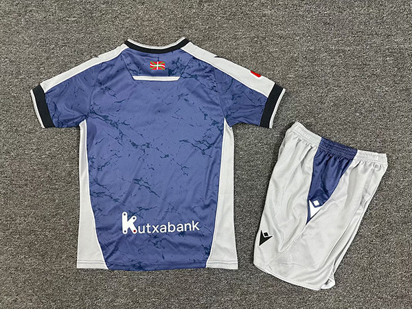 CAMISOLA REAL SOCIEDAD II 2526 CONJUNTO INFANTIL