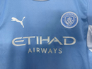 CAMISOLA MANCHESTER CITY PRINCIPAL 2026/27 CONJUNTO INFANTIL