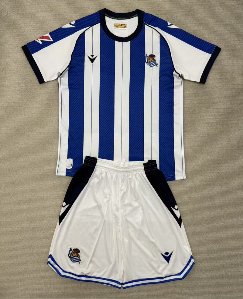 Camisola Real Sociedad I 2526 – Conjunto Infantil